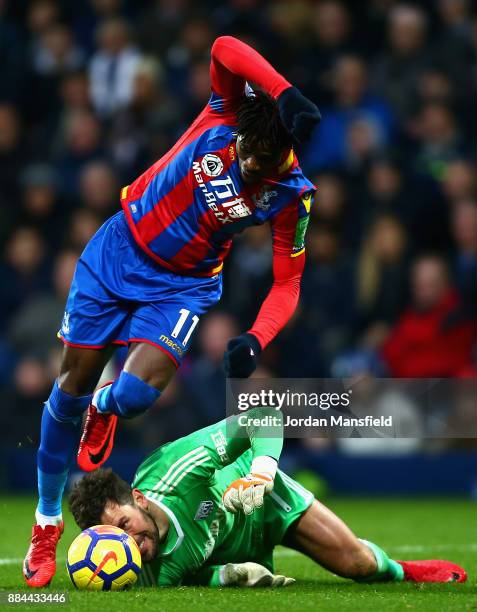 Ben Foster of West Bromwich Albion attempts to head the ball while under pressure from Wilfried Zaha of Crystal Palace during the Premier League...