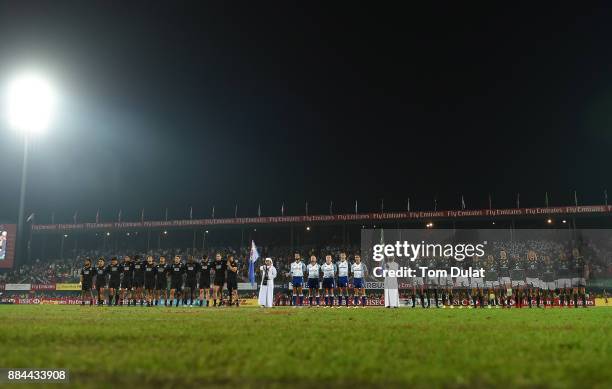 Both teams line up for the national anthems during the Cup Final match between South Africa and New Zealand on Day Three of the Emirates Dubai Rugby...