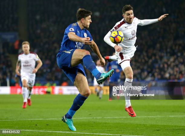 Harry Maguire of Leicester City is challenged by Stephen Ward of Burnley during the Premier League match between Leicester City and Burnley at The...