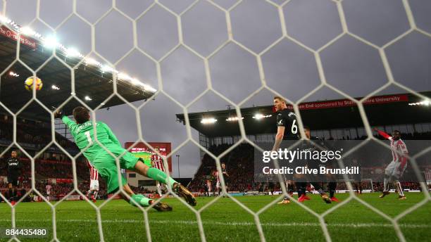 Mame Biram Diouf of Stoke City scores his sides second goal past Lukasz Fabianski of Swansea City during the Premier League match between Stoke City...