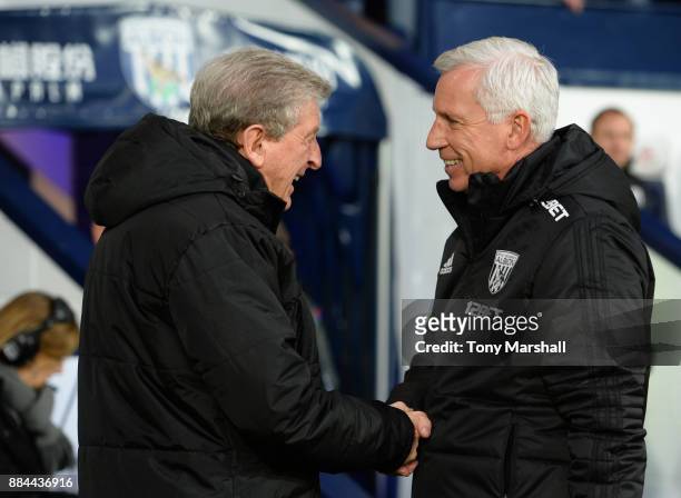 Roy Hodgson, Manager of Crystal Palace and Alan Pardew, Manager of West Bromwich Albion embrace prior to the Premier League match between West...