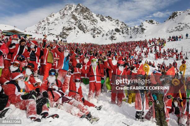 More that 2,000 people disguised as Santa Claus pose for a picture at the ski resort of Verbier, Swiss Alps, on December 2, 2017. The ski resort...