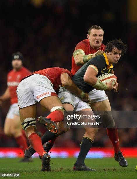 Springboks player Francois Venter is tackled by Hadleigh Parkes of Wales during the International between Wales and South Africa at at Principality...