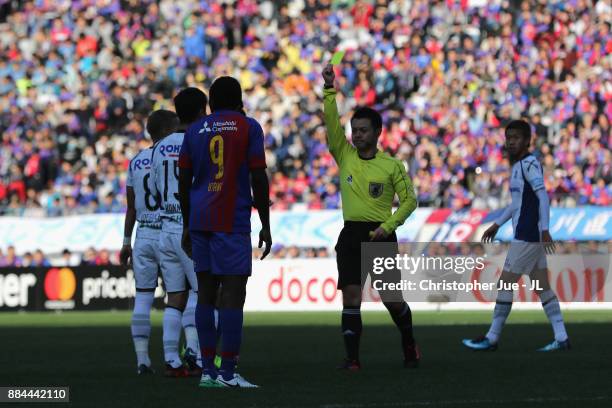 Yasuyuki Konno of Gamba Osaka is shown a yellow card by referee Koichiro Fukushima during the J.League J1 match between FC Tokyo and Gamba Osaka at...