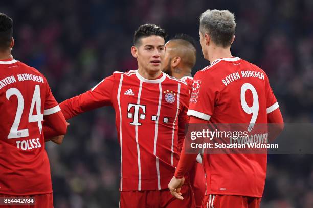 Robert Lewandowski of Bayern Muenchen celebrates with James Rodriguez of Bayern Muenchen after he scored a penalty goal to make it 3:1 during the...