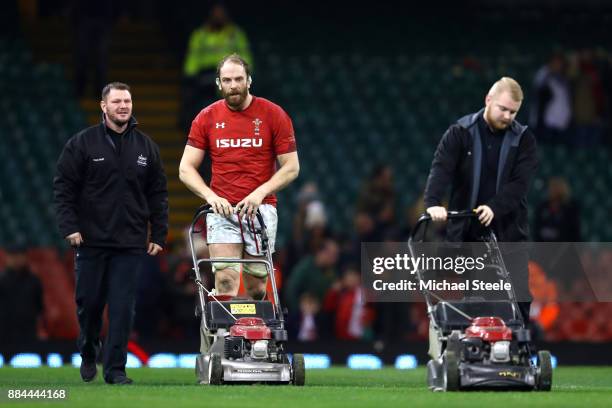 Alun Wyn Jones of Wales helps the groundmen after the game to mow the grass during the international match match between Wales and South Africa at...