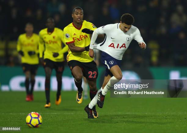 Dele Alli of Tottenham Hotspur is challenged by Marvin Zeegelaar of Watford during the Premier League match between Watford and Tottenham Hotspur at...