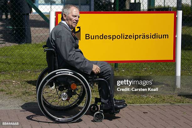 German Interior Minister Wolfgang Schaeuble passes a sign at the headquarter of the federal police during his visit on June 12, 2009 in Potsdam,...