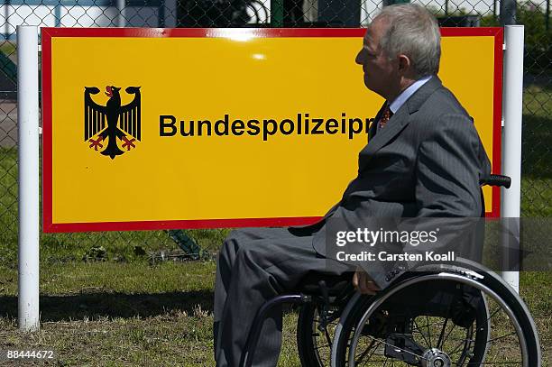 German Interior Minister Wolfgang Schaeuble passes a sign at the headquarter of the federal police during his visit on June 12, 2009 in Potsdam,...