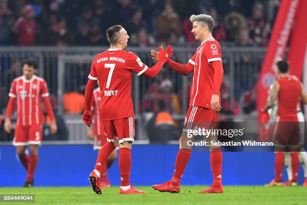 Franck Ribery of Bayern Muenchen shakes hands with Robert Lewandowski of Bayern Muenchen after the Bundesliga match between FC Bayern Muenchen and...