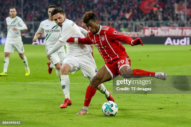 Julian Korb of Hannover and Kingsley Coman of Bayern Muenchen battle for the ball during the Bundesliga match between FC Bayern Muenchen and Hannover...