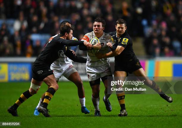 Will Evans of Leicester Tigers is tackled by Danny Cipriani and Jimmy Gopperth of Wasps during the Aviva Premiership match between Wasps and...