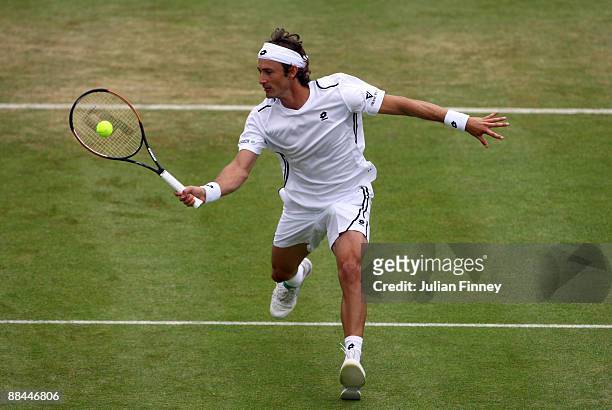 Juan Carlos Ferrero of Spain plays a forehand volley during the men's quarter final match against Steve Darcis of Belgium during Day 5 of the the...