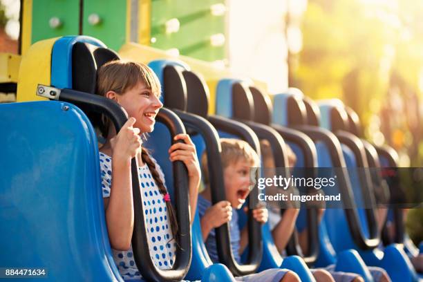 kids having extreme fun in amusement park drop tower - amusement ride stock pictures, royalty-free photos & images