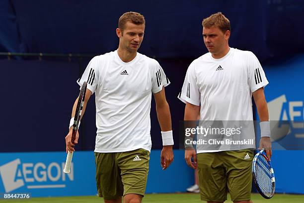 Mariusz Fyrstenberg of Poland talks with Marcin Matkowski of Poland during the men's doubles quarter final match against Jeff Coetzee of South Africa...