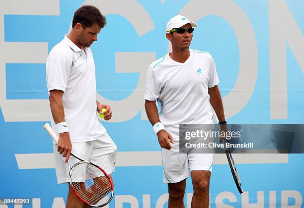 Jeff Coetzee of South Africa talks with Jordan Kerr of Australia during the men's doubles quarter final match against Mariusz Fyrstenberg of Poland...