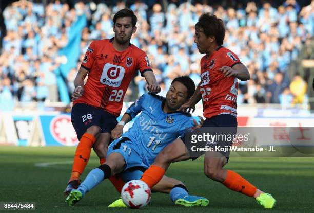 Yu Kobayashi of Kawasaki Frontale competes for the ball against Ariajasuru Hasegawa and Kazuma Takayama of Omiya Ardija during the J.League J1 match...