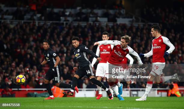 Jesse Lingard of Manchester United scores his sides second goal as Nacho Monreal of Arsenal attempts to tackle him during the Premier League match...