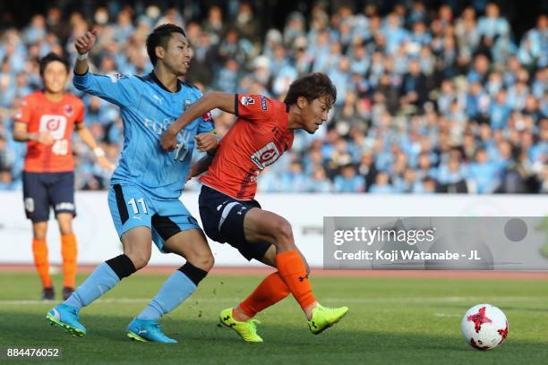 Kazuma Takayama of Omiya Ardija controls the ball under pressure of Yu Kobayashi of Kawasaki Frontale during the J.League J1 match between Kawasaki...