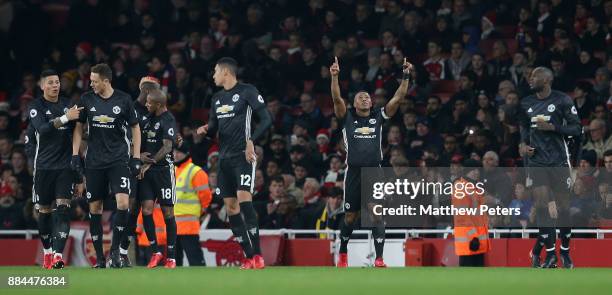 Antonio Valencia of Manchester United celebrates scoring their first goal during the Premier League match between Arsenal and Manchester United at...