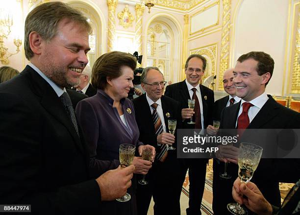 Russian President Dmitry Medvedev toasts with prize-winners of Russia's State Awards the creator of anti-virus protection of computer information...