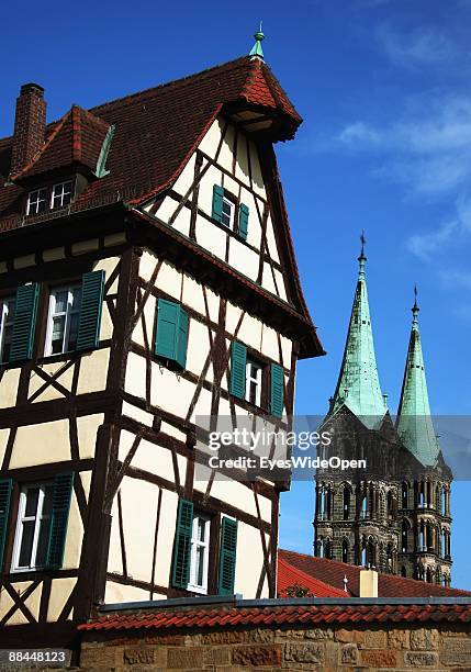 Two towers of the dome of Sankt Peter and St. Georg and a traditional house on June 11, 2009 in Bamberg, Germany. Bamberg is listed as a World...