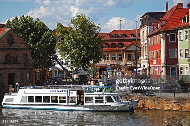 Tourist boat on the river Regnitz on June 11, 2009 in Bamberg, Germany. Bamberg is listed as a World Heritage by UNESCO.
