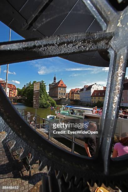 Tourist boat and the former City Hall at the river Regnitz with its facade in rococo style on June 11, 2009 in Bamberg, Germany. Bamberg is listed as...