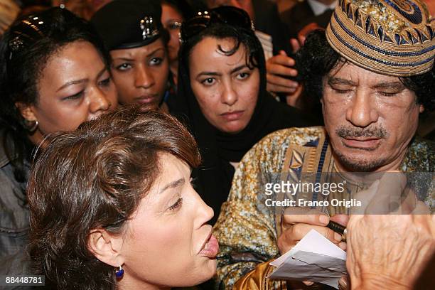 Lybia's Leader Muammar Gaddafi signs autographs as he leaves the Auditorium Parco Della Musica after a meeting with seven hundred Italian women on...