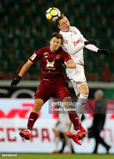 Dmitri Tarasov of FC Lokomotiv Moscow vies for the ball with Maksim Kanunnikov of FC Rubin Kazan during the Russian Premier League match between FC...