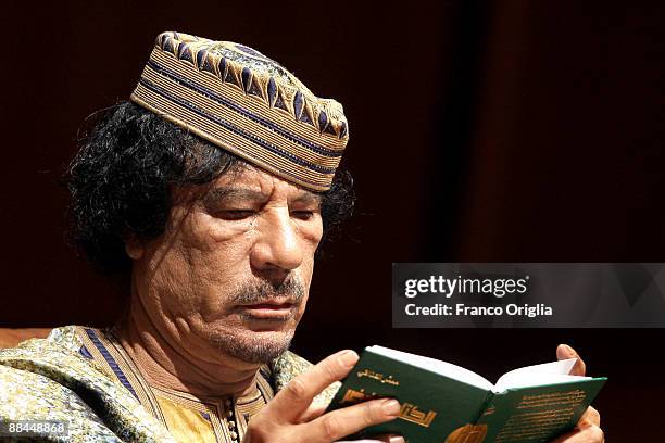 Lybia's Leader Muammar Gaddafi reads his Green Book as he attends a meeting with seven hundred Italian women at the Auditorium Parco Della Musica on...