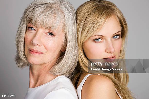 young woman and senior woman - senior woman studio ストックフォトと画像