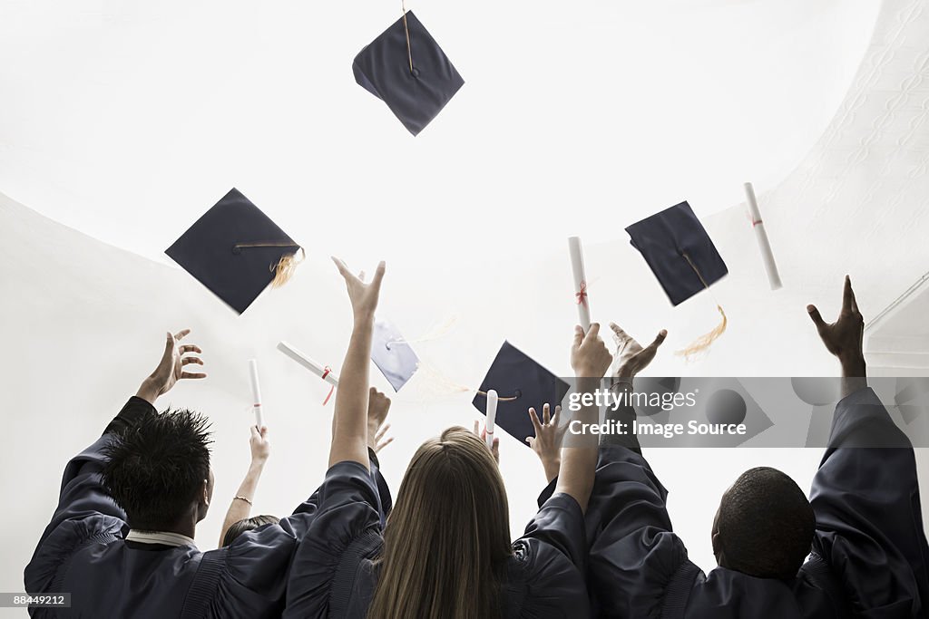 Graduates throwing mortarboards
