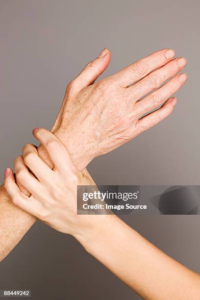 hands on young and older women - liver spot stock pictures, royalty-free photos & images