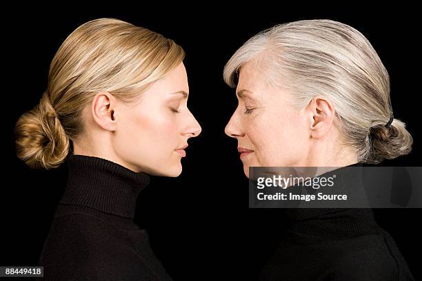 young and senior women face to face - young at heart stock pictures, royalty-free photos & images