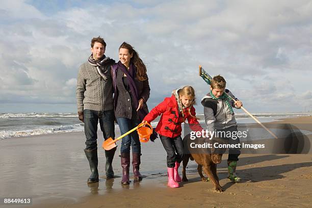 family and dog by the sea - dutch family stockfoto's en -beelden