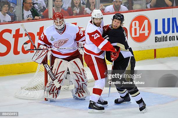 Goaltender Chris Osgood and Brad Stuart of the Detroit Red Wings against Jordan Staal of the Pittsburgh Penguins during Game Six of the NHL Stanley...