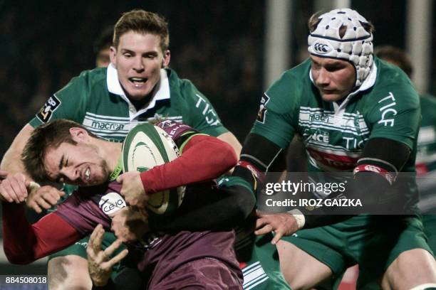 Bordeaux's winger Geoffrey Cros is tackled by Pau's New Zealander center Conrad Smith during the French Top 14 rugby union match between Pau and...