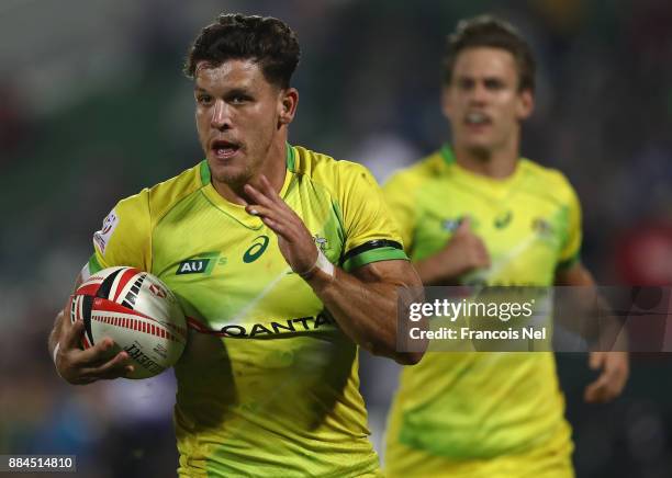 Simon Kennewell of Australia runs with the ball during the match between and on Day Three of the Emirates Dubai Rugby Sevens - HSBC Sevens World...