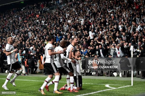 Besiktas' defender Dusko Tosic celebrates with his teammates after scoring a goal during the Turkish Super Lig football match between Besiktas and...