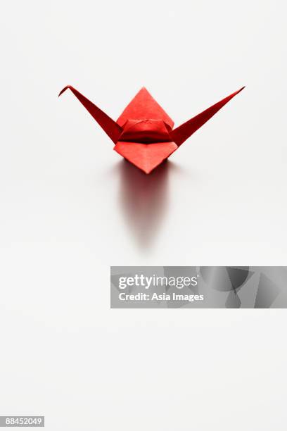 single red paper crane - paper cranes stock pictures, royalty-free photos & images