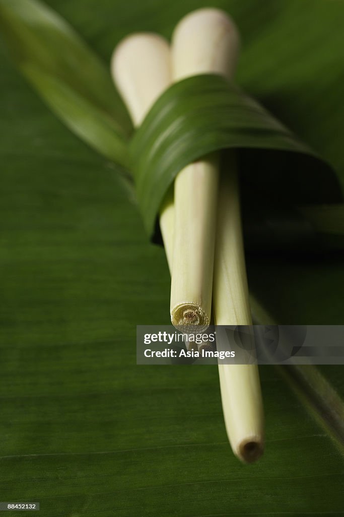 Lemon grass stalks placed on top of banana leaf