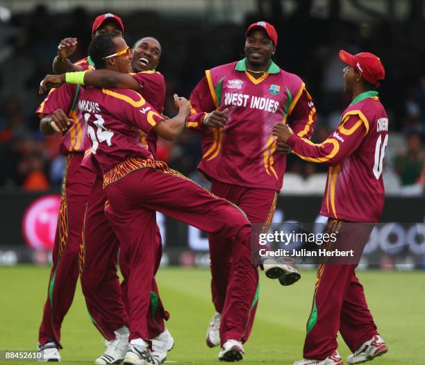 Dwayne Bravo of West Indies celebrates the wicket of Gautam Gambhir of India with Lendl Simmons during the ICC World Twenty20 Super Eights match...