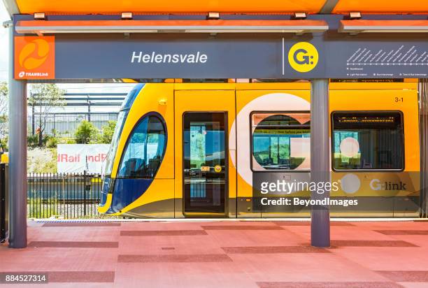 g:link tram waiting at new helensvale terminus and transport interchange - lightrail stock pictures, royalty-free photos & images