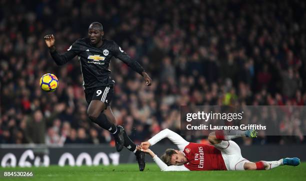 Romelu Lukaku of Manchester United escapes the challenge of Nacho Monreal of Arsenal during the Premier League match between Arsenal and Manchester...