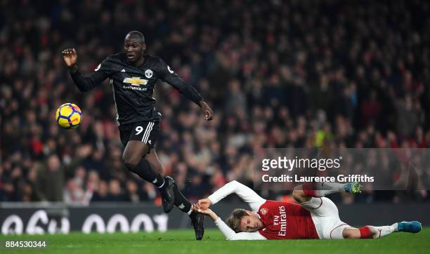 Romelu Lukaku of Manchester United escapes the challenge of Nacho Monreal of Arsenal during the Premier League match between Arsenal and Manchester...