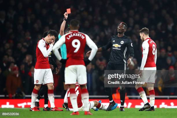 Paul Pogba of Manchester United is shown a red card by referee Andre Marriner for stamping on Hector Bellerin of Arsenal during the Premier League...