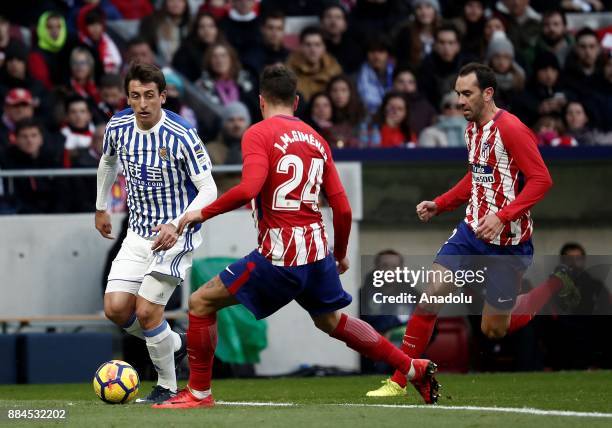 Jose Gimenez of Atletico de Madrid in action against Mikel Oyarzabal of Real Sociedad during the La Liga match between Club Atletico Madrid and Real...