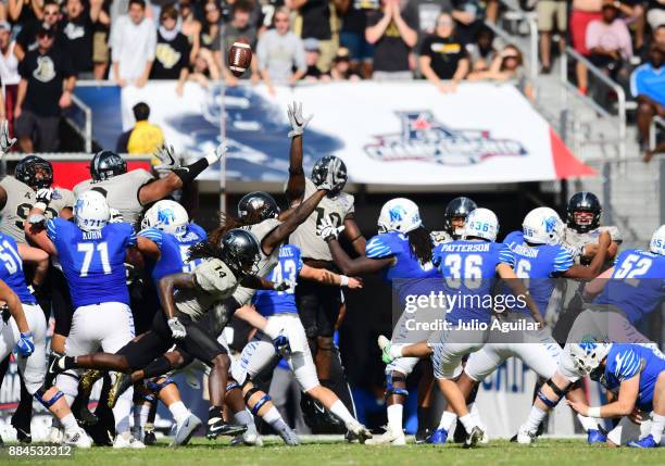 Place kicker Riley Patterson of the Memphis Tigers kicks a field goal to end the second quarter and put Memphis up 31-24 during the ACC Championship...