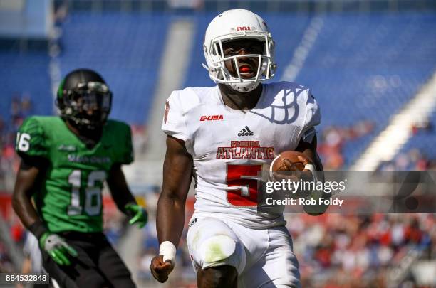 Devin Singletary of the Florida Atlantic Owls rushes for a touchdown past Kemon Hall of the North Texas Mean Green during the Conference USA...